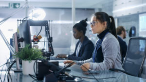 Women looking a data computer