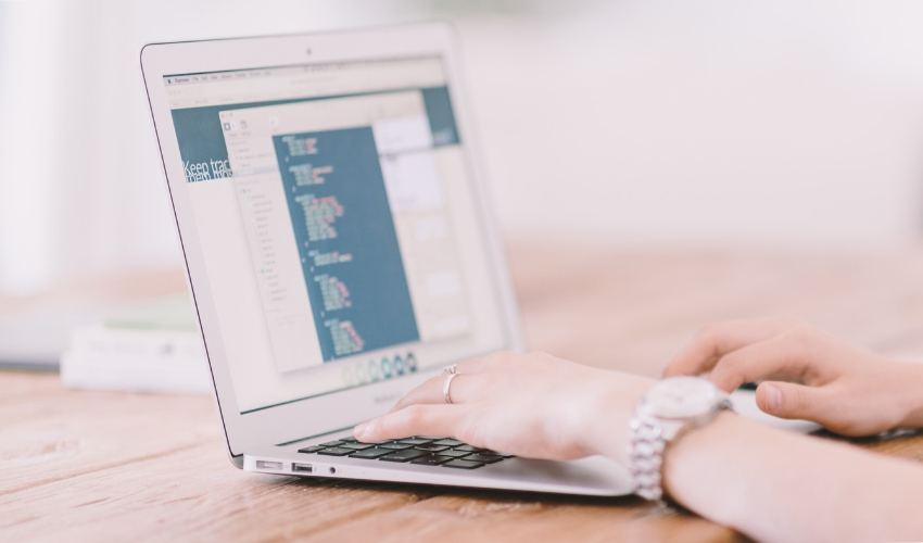 Woman coding on a laptop