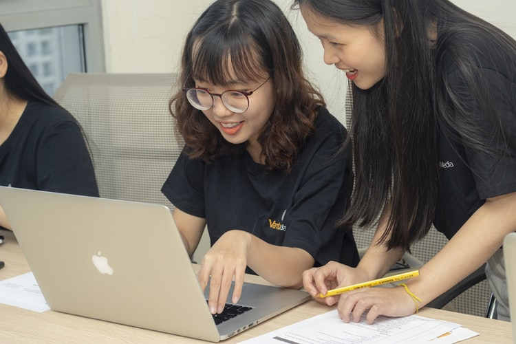 Group of Girls working around a computer