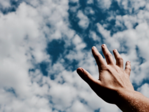 Man reaching for the clouds